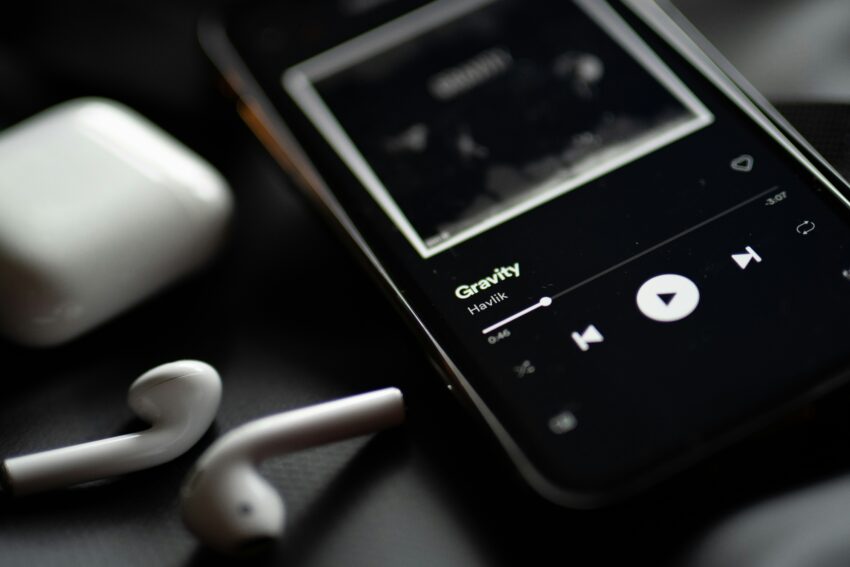 Phone screen showing music streaming app, illustrating mix engineer credit on a Spotify song credits panel