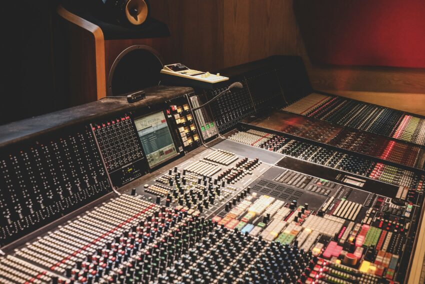 Mixing console faders before printing a mix for mastering