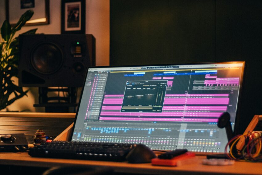 Music production studio computer where a mix engineer inspects AI separated stems sent by a client